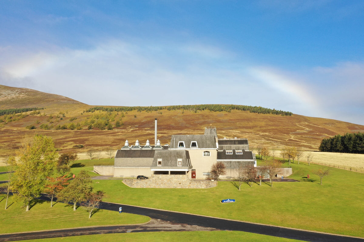 A rainbow over Allt-A-Bhainne Distillery in the Speyside hills