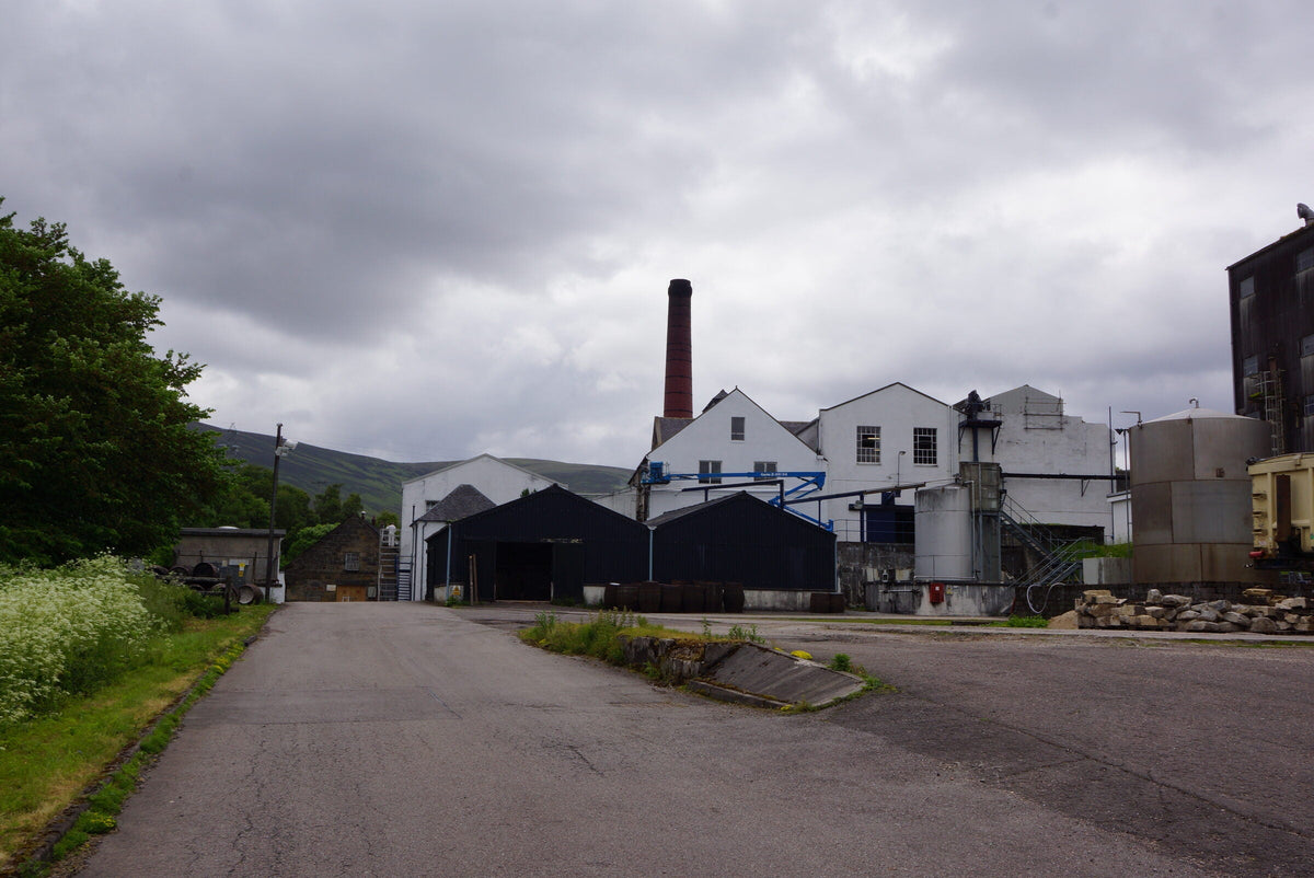 The old buildings and brick chimney at Balmenach Distillery in Speyside