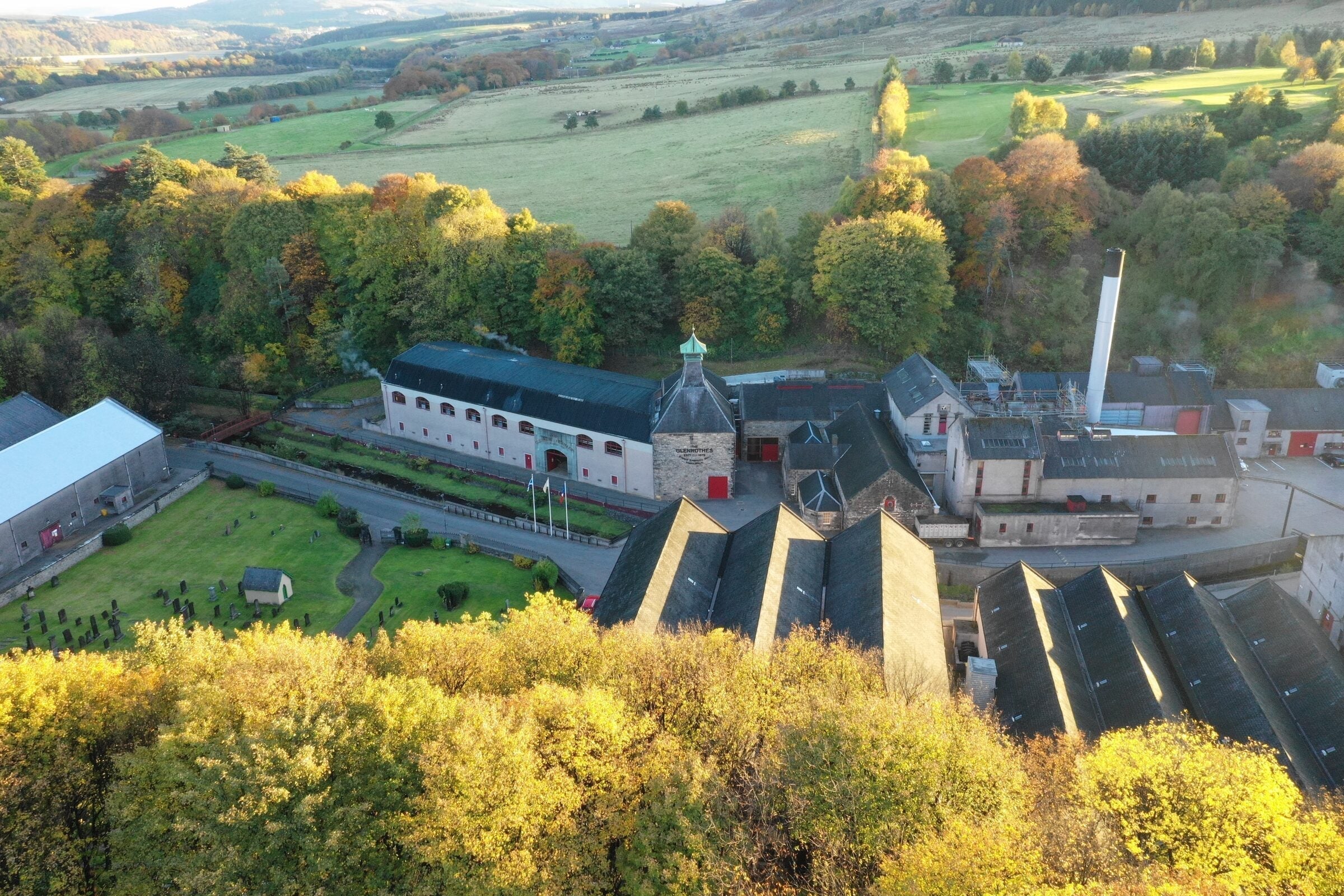 Aerial view of The Glenrothes Distillery nestled among autumn trees at Rothes, Speyside